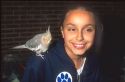 Girl with pet bird on her shoulder.  MR