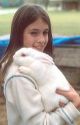 Young girl holding a pet rabbit.  MR