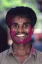 Male indian with his face painted in purple color for the Holi Festival in India.