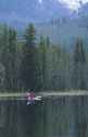 A couple kayaking on Warm Lake in the Boise National Forest, Idaho.