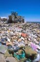 Sanitary landfill with  compactors at work.