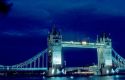 Tower bridge spanning the River Thames in London, England at night.