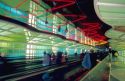 Moving sidewalk with neon lights overhead in the United terminal at Chicago's O'hare airport.