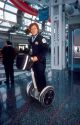 Female Chicago police officer riding a Segue gyro scooter at O'hare airport.