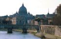 St. Peter's Basilica looms over the Tiber River in Rome, Italy.