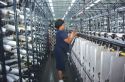 Woman employee works at the Coats and Clark yarn factory in Douglas, Georgia.