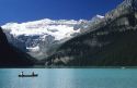 People canoeing on Lake Louise with a glacier in the background in Banff National Park, Canada.