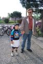 Italian father and son holding hands enroute to school.  The white apron is part of the elementary school uniform.