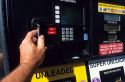 Inserting a credit card as payment for unleaded gasoline at the pump.