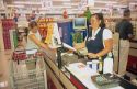 Woman customer checking out at the grocery store.