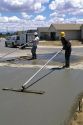 Workers floating a concrete slab.