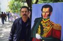 An artist with a painting of Simon Bolivar in Venezuela.