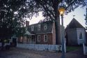 View of Colonial Williamsburg, Virginia at dusk along Duke of Gloucester Street.