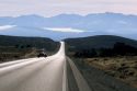 U.S. Hihghway 95 forms a ribbon of highway in northern Nevada with the Ruby Mountains in background.