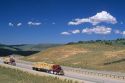 Trucks hauling an oversized load of lumber on Interstate 80 in Wyoming.