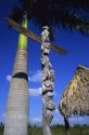 Totem pole with palm tree and chopekcheke. A traditional Seminole Miccosukee Indian dwelling.