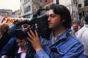 An Italian television news cameraman.