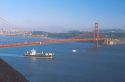 Cargo ship passing under the Golden Gate Bridge in San Francisco, California.