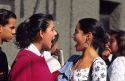 Mexican teen girls talk outside highschool in Mexico City.