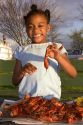 African american girl eating crawfish in New Orleans, Louisiana.