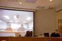 Video arraignment in criminal court in Boise, Idaho.  Defendants appear on video screen from secure jail facility while judge in courtroom conducts arraignment and sets bond.