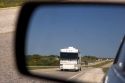 A recreational vehicle seen through aan automobile rear view mirror on the Interstate 10 in West Texas.