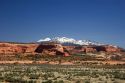 A view of snowy La Sal mountains and sandstone along US highway 191 south of Moab, Utah.