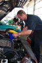 Automechanic changing the oil in a car.
