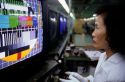 A woman works at a television factory in Taipei, Taiwan.