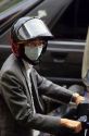 A man wearing a face mask to filter pollution rides a scooter in Taipei, Taiwan.