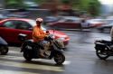 A woman wears a face mask to filter pollution while riding a scooter in Taipei, Taiwan.