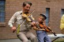 Manny Shaw plays the fiddle with a young boy at the Fiddle Festival in Weiser, Idaho.