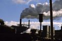 Smoke stacks emit air pollution at a manufacturing plant.