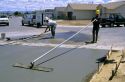 Workers floating a concrete driveway at a subdivision in Idaho.