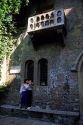 An Italian couple kissing below the balcony of Juliets house in Verona, Italy.