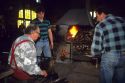 Glass blowing in Algaida, Majorca, Spain.  Master, seated, apprentice at left, and journeyman at right.