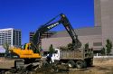 Track power shovel and dump truck on a building construction site in Boise, Idaho.