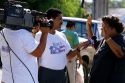 A television reporter interviews a woman in Puerto Rico.