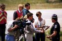 Television reporters interview an Idaho State Trooper.