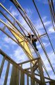 Construction worker using wood trusses for roof frame in Boise, Idaho.