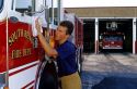 Firefighter polishing a fire truck in South Bend, Indiana.