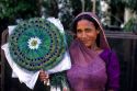 A street vendor selling peacock feather fans in Bombay, India.