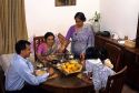 A middle class Indian family is sewrved a meal by grandmother at home in Bangalore, India.