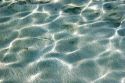 Dappled clear water and sandy bottom of the lagoon on the island of Moorea.
