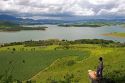 Woman standing on a rock overlooking a reservoir and the countryside near Sao Paulo, Brazil. MR