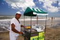 Vendor selling ears of corn on the beach at Pinamar, Argentina.