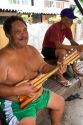 Tahitian man playing the ukelele with nylon strings in Papeete on the island of Tahiti.