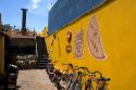 Yellow wall and bicycles at a parrillada restaurant  in Colonia, Uraguay.