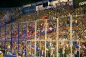 Crowds behind security fences watch a soccer game at the West Stadium in Buenos Aires, Argentina.