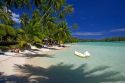 Beach scene with lagoon and palm trees on the island of Moorea at Hotel Tipaniers.